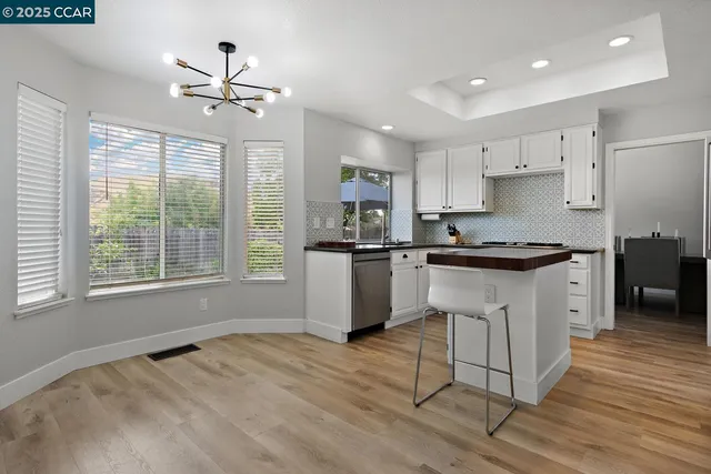 a kitchen with granite countertop a sink and cabinets