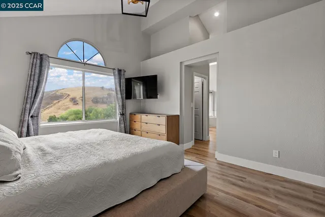 a view of an empty room and wooden floor