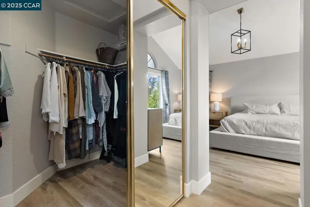 a large bed sitting in a bedroom next to a window