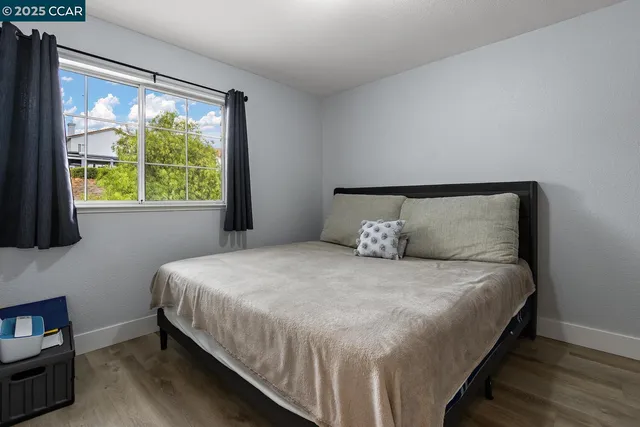 a bathroom with a granite countertop sink vanity mirror and toilet