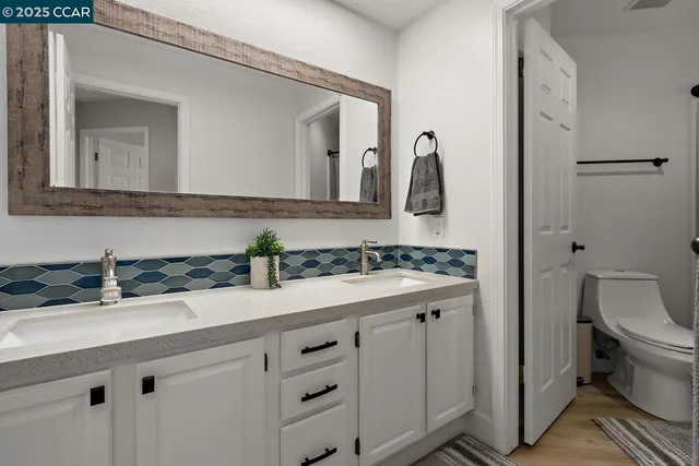 a white toilet sitting next to a shower