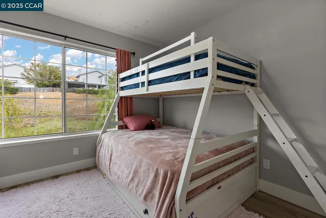 a bathroom with a granite countertop sink a toilet and mirror