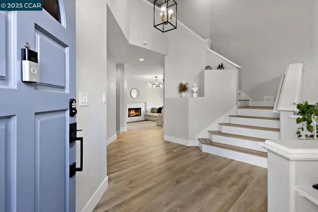 a view of a dining room with furniture and chandelier