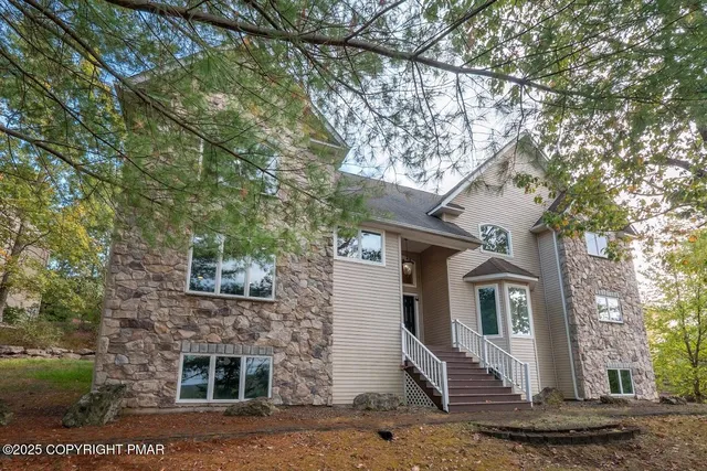 a dining room with furniture a rug a rug and a chandelier