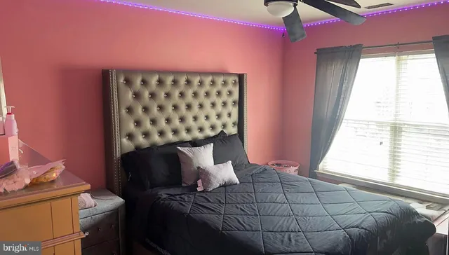 a bedroom with a bed and a window