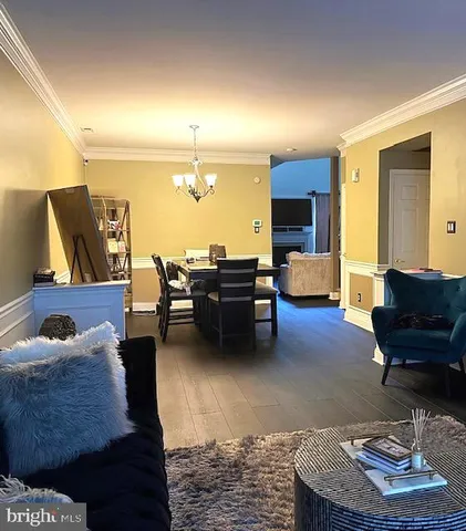 a living room with furniture and a lamp on table and chair