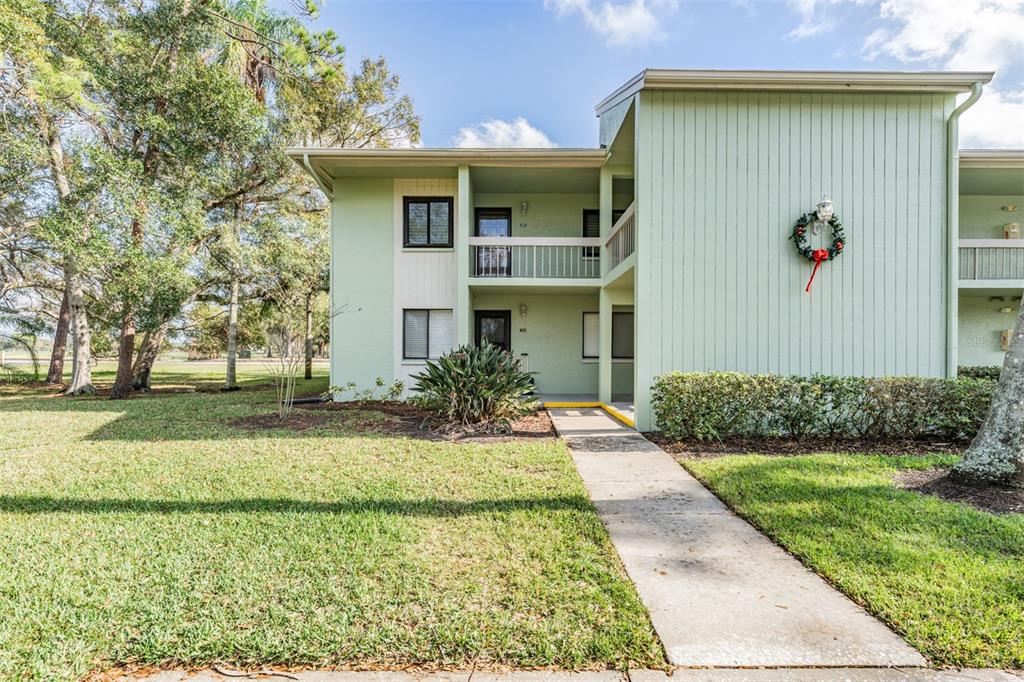 232 Caryl Way, Unit 232 Oldsmar, FL 34677 - Photo 1 of 1 a front view of a house with a yard