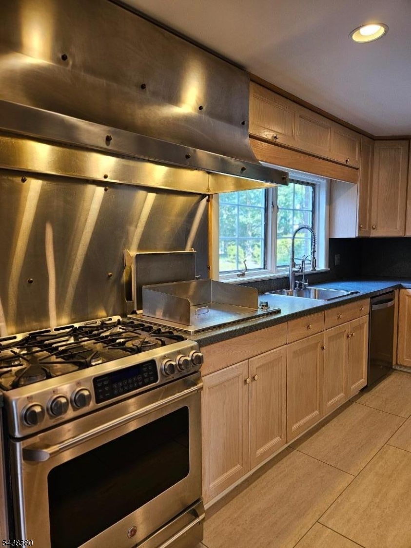 218 Devon Road Essex Fells, NJ 07021 - Photo 8 of 24 a kitchen with granite countertop a stove top oven cabinetry a sink and a window