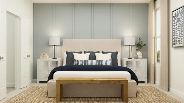 a bedroom with a bed and a mirror