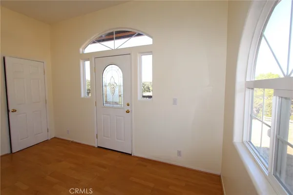 a view of a livingroom with wooden floor and window