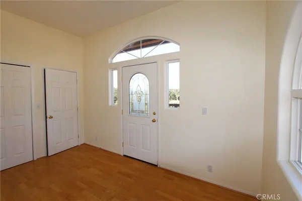a view of a room that has a large window and mirror
