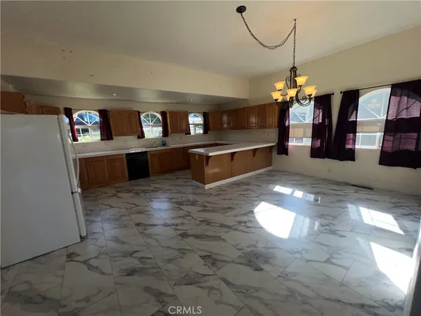 a lobby with furniture and chandelier