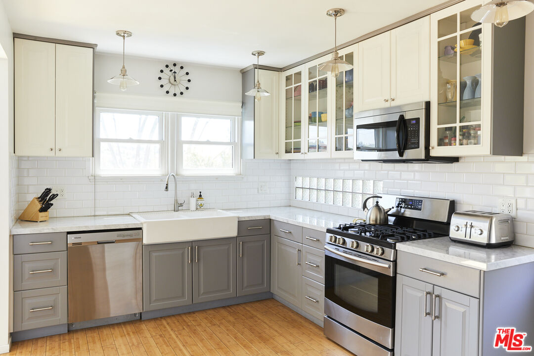 3708 Roderick Road Los Angeles, CA 90065 - Photo 14 of 38 a kitchen with cabinets appliances a sink and a window