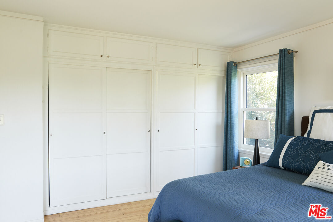 3708 Roderick Road Los Angeles, CA 90065 - Photo 23 of 38 a bedroom with a bed and wooden floor