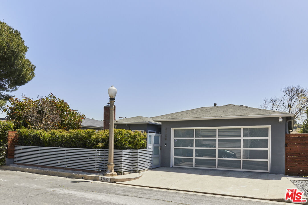 3708 Roderick Road Los Angeles, CA 90065 - Photo 3 of 38 a front view of a house with a yard and garage
