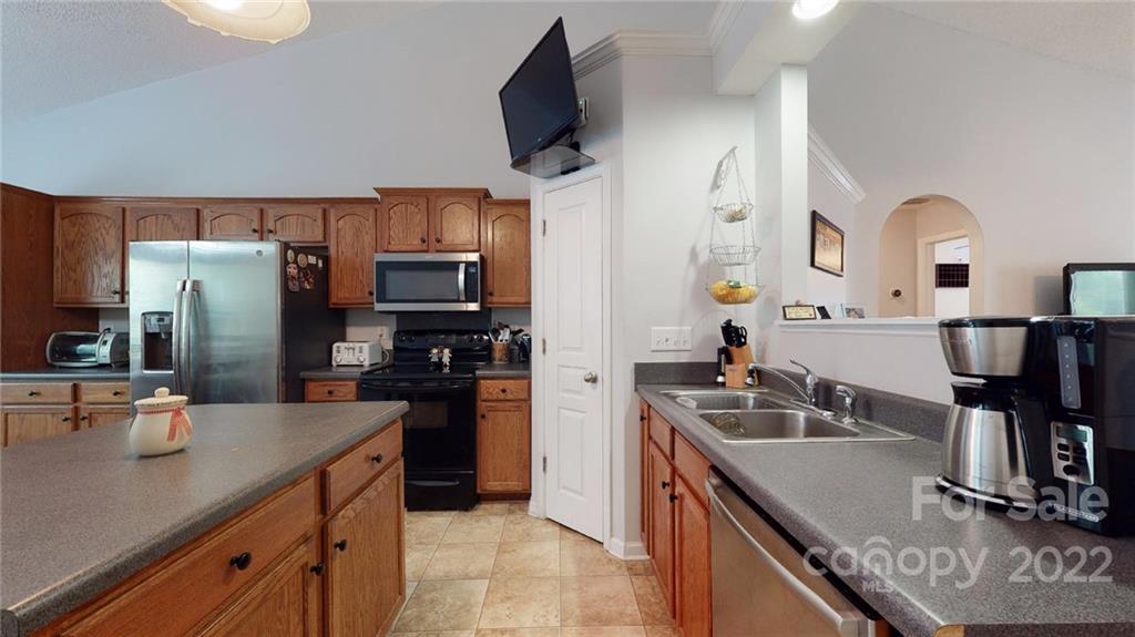 1447 George Dunn Road Rock Hill, SC 29730 - Photo 17 of 44 a kitchen with stainless steel appliances granite countertop a sink refrigerator and microwave