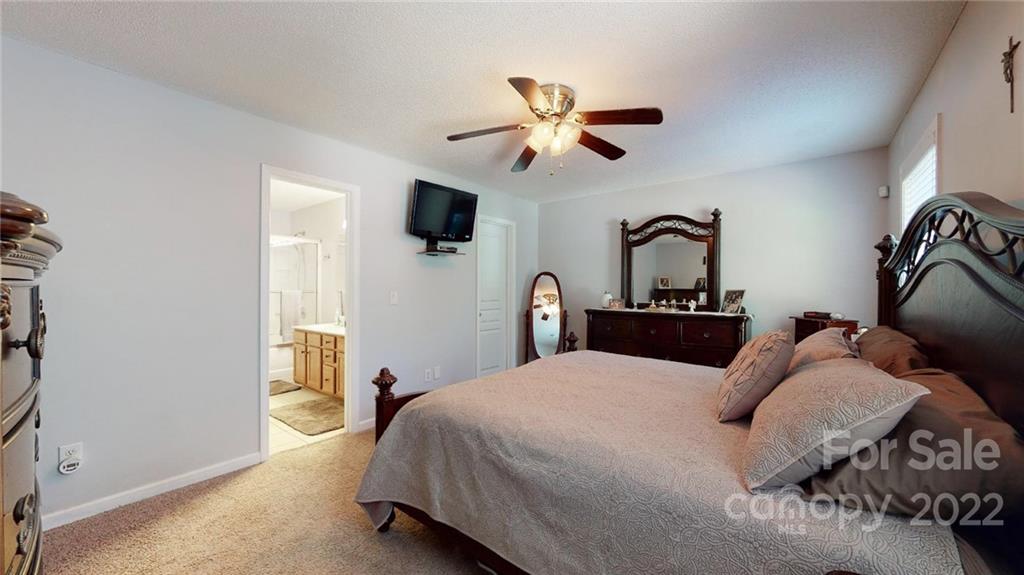 1447 George Dunn Road Rock Hill, SC 29730 - Photo 24 of 44 a bedroom with a bed and a chandelier