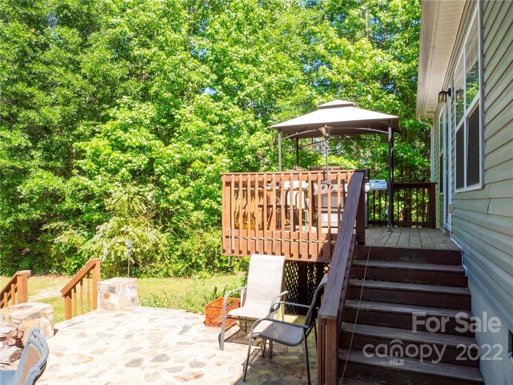 1447 George Dunn Road Rock Hill, SC 29730 - Photo 34 of 44 a view of a deck with a table and chairs under an umbrella with wooden fence