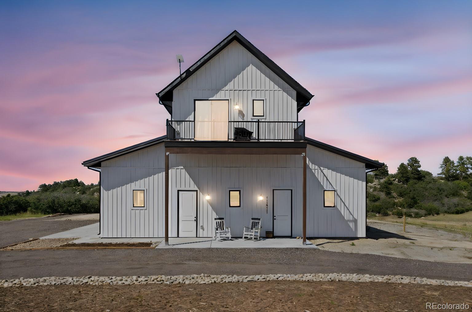 Lot 4 Wildstone Ranch Elbert, CO 80106 - Photo 11 of 42 a front view of a house with a yard and garage