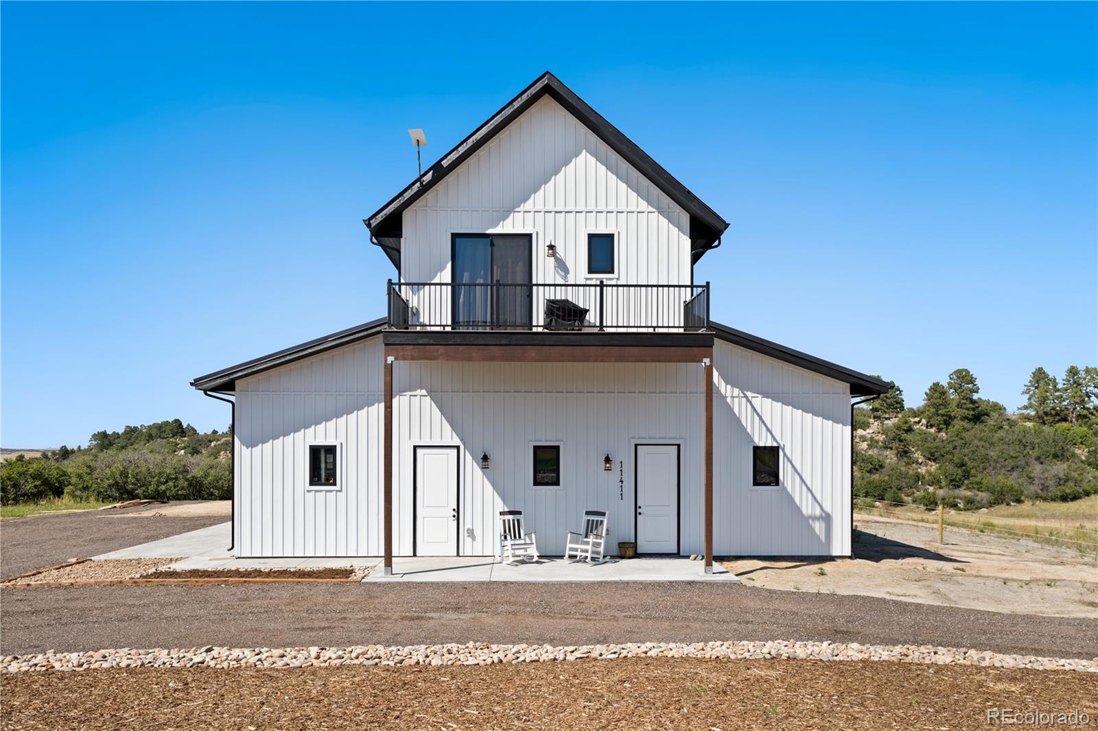 Lot 4 Wildstone Ranch Elbert, CO 80106 - Photo 28 of 42 a view of a house with a yard and garage