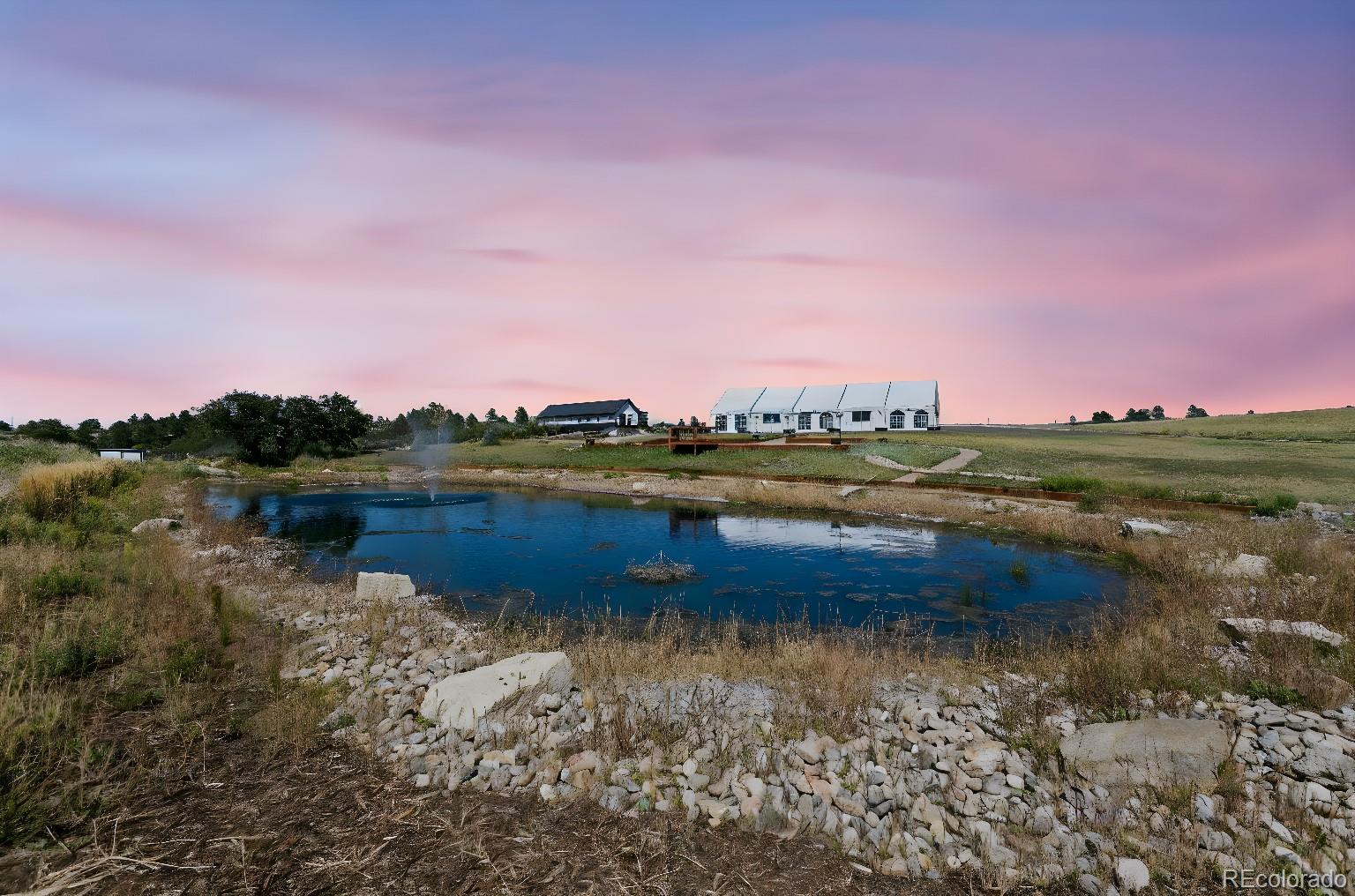 Lot 4 Wildstone Ranch Elbert, CO 80106 - Photo 4 of 42 a view of a lake with houses in the background