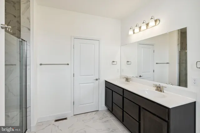 a bathroom with a double vanity sink mirror and