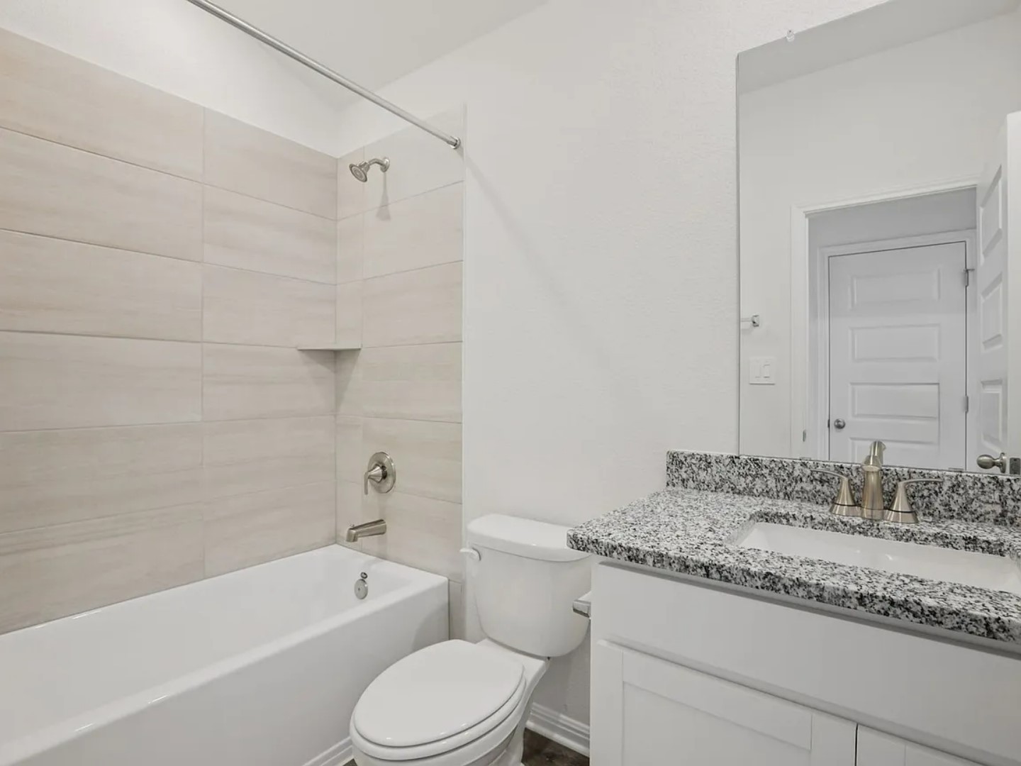 486 El Capitan Loop Dripping Springs, TX 78620 - Photo 9 of 20 a bathroom with a granite countertop sink a toilet and bathtub