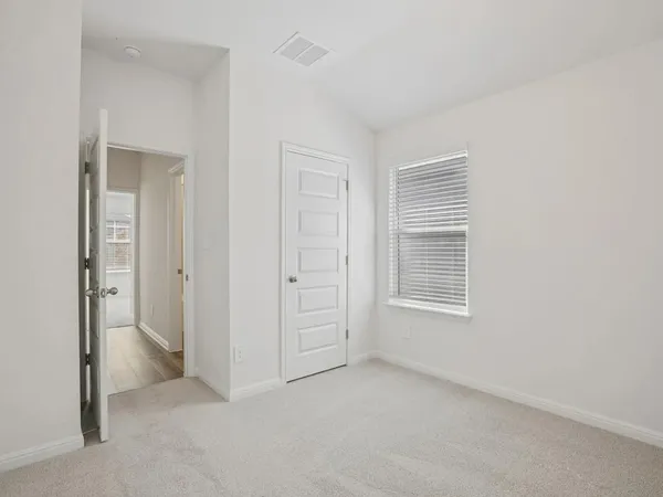 an empty room with closet area