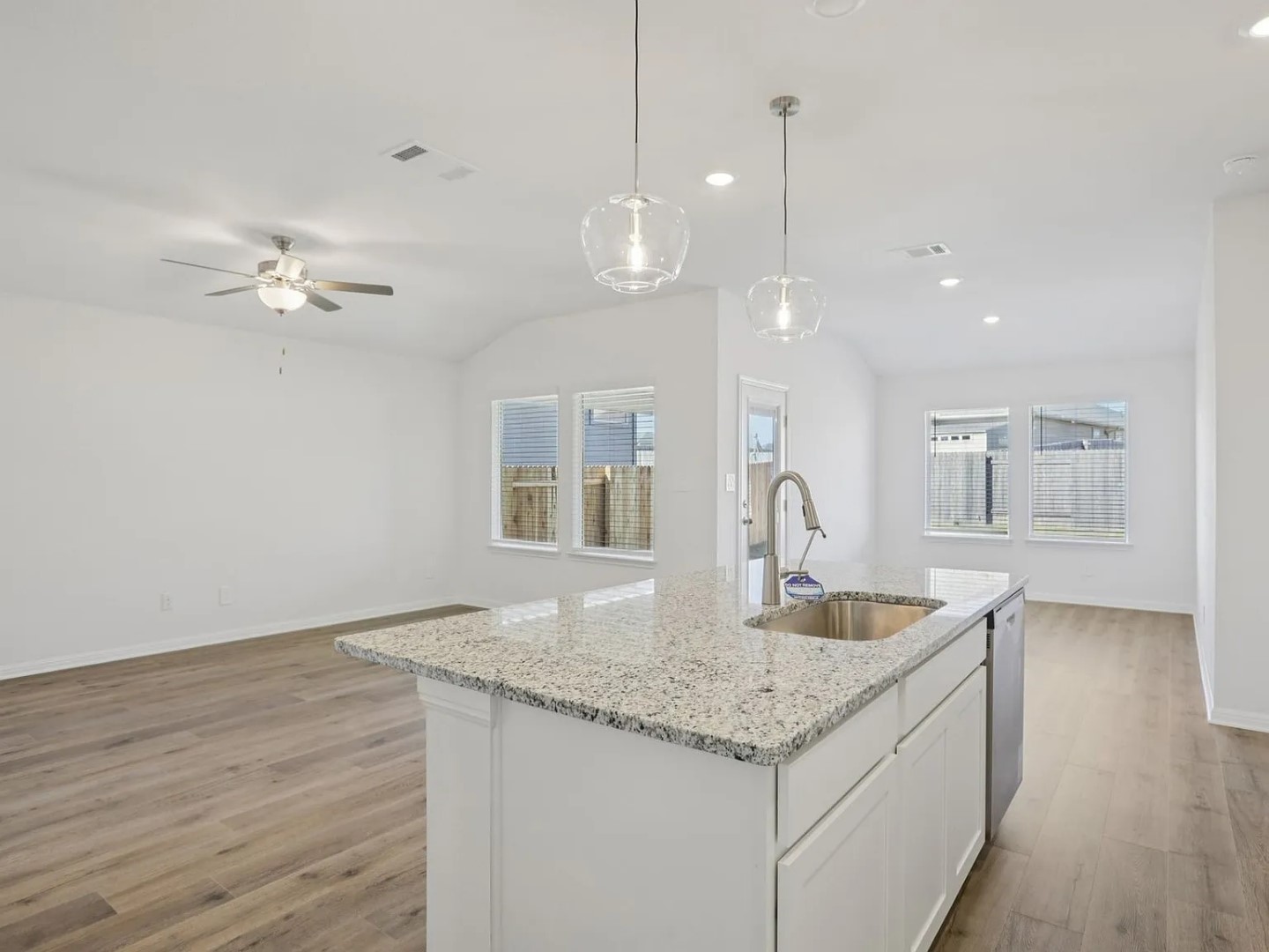 486 El Capitan Loop Dripping Springs, TX 78620 - Photo 20 of 20 a kitchen with granite countertop a sink a center island and cabinets