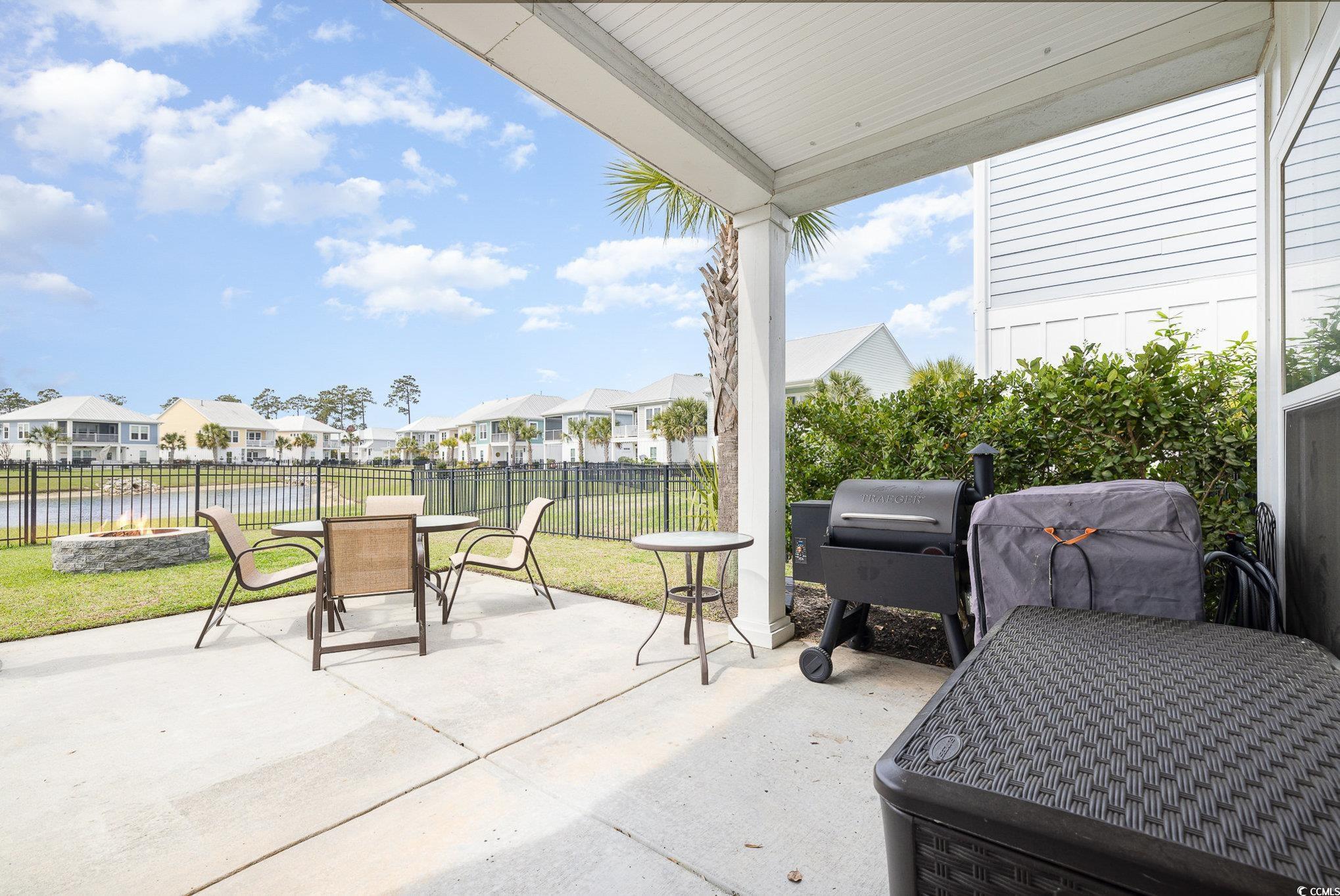 136 Splendor Circle Murrells Inlet, SC 29576 - Photo 23 of 30 View of patio / terrace featuring outdoor dining area, a fire pit, grilling area, and a residential view
