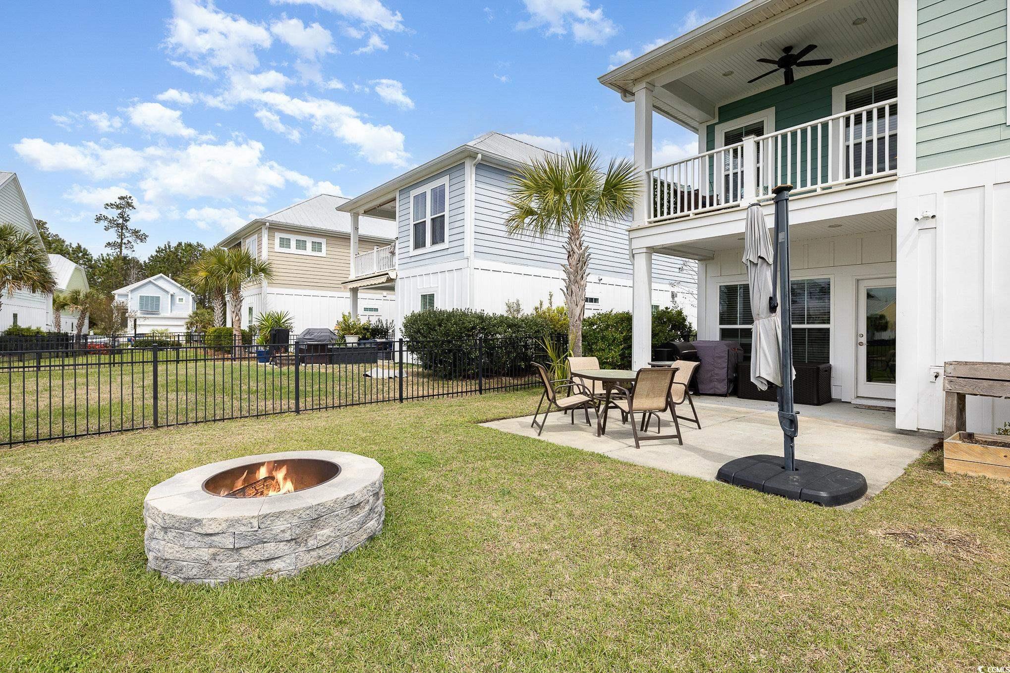 136 Splendor Circle Murrells Inlet, SC 29576 - Photo 24 of 30 View of yard featuring a fire pit, a patio area, fence, a balcony, and ceiling fan