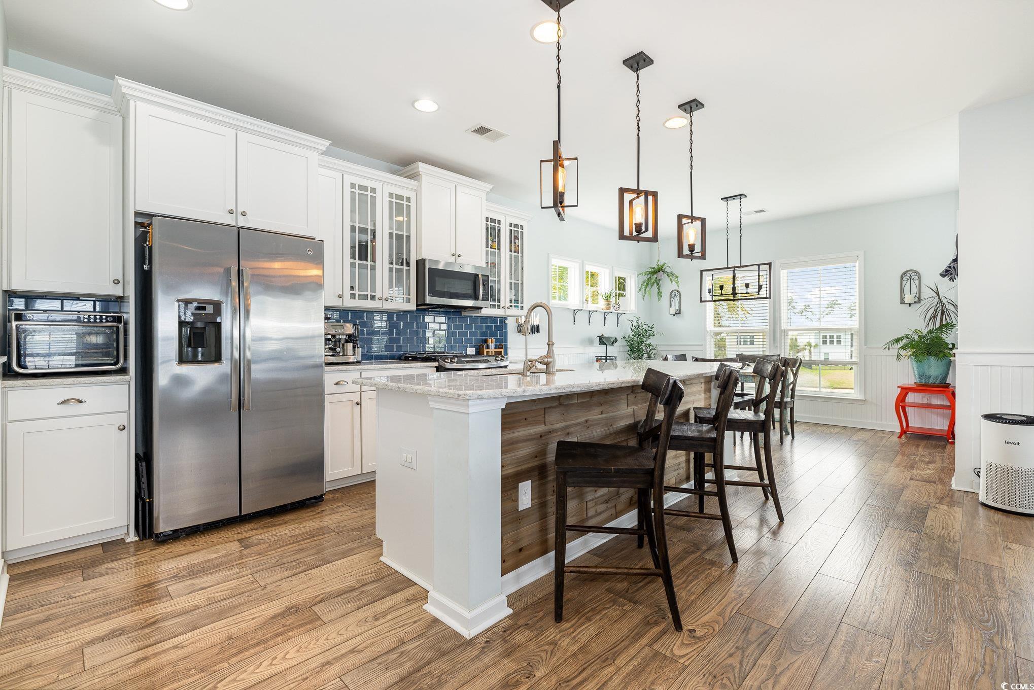 136 Splendor Circle Murrells Inlet, SC 29576 - Photo 8 of 30 Kitchen featuring a kitchen island with sink, a sink, stainless steel appliances, and light wood-style floors
