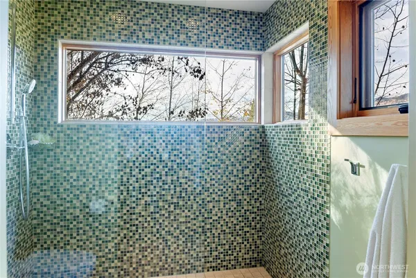 a bathroom with a shower curtain and a large window