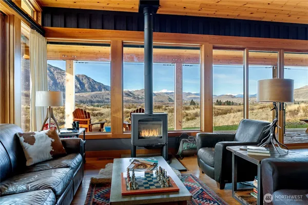 a living room with furniture city view and large windows