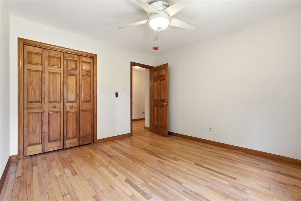170 East Hadley Road, Unit 96 Amherst, MA 01002 - Photo 22 of 36 a view of an empty room with wooden floor