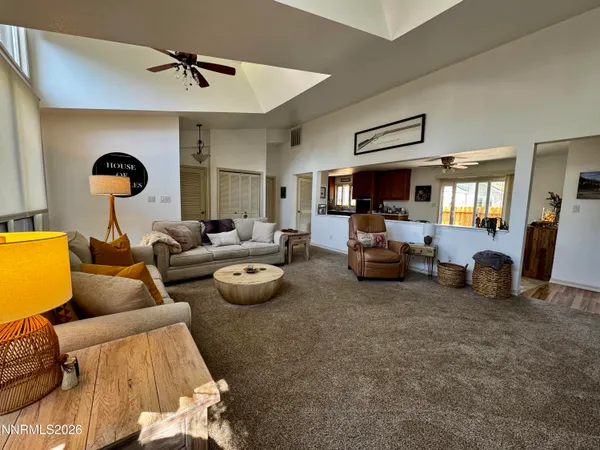 a view of a livingroom with furniture and a kitchen