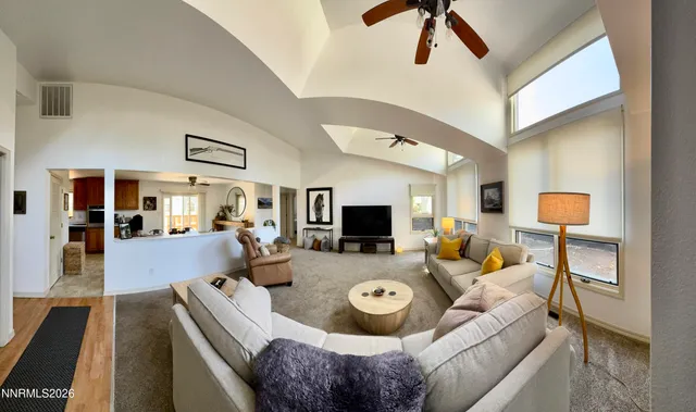 a bedroom with a large bed and a ceiling fan