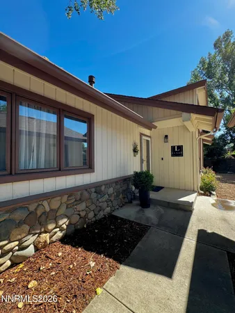 a living room with furniture a flat screen tv and a window