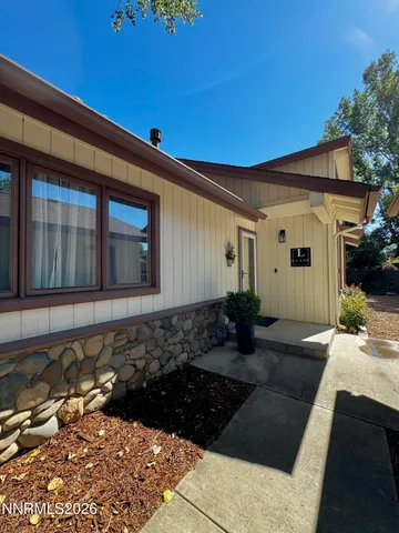 a living room with furniture a flat screen tv and a window