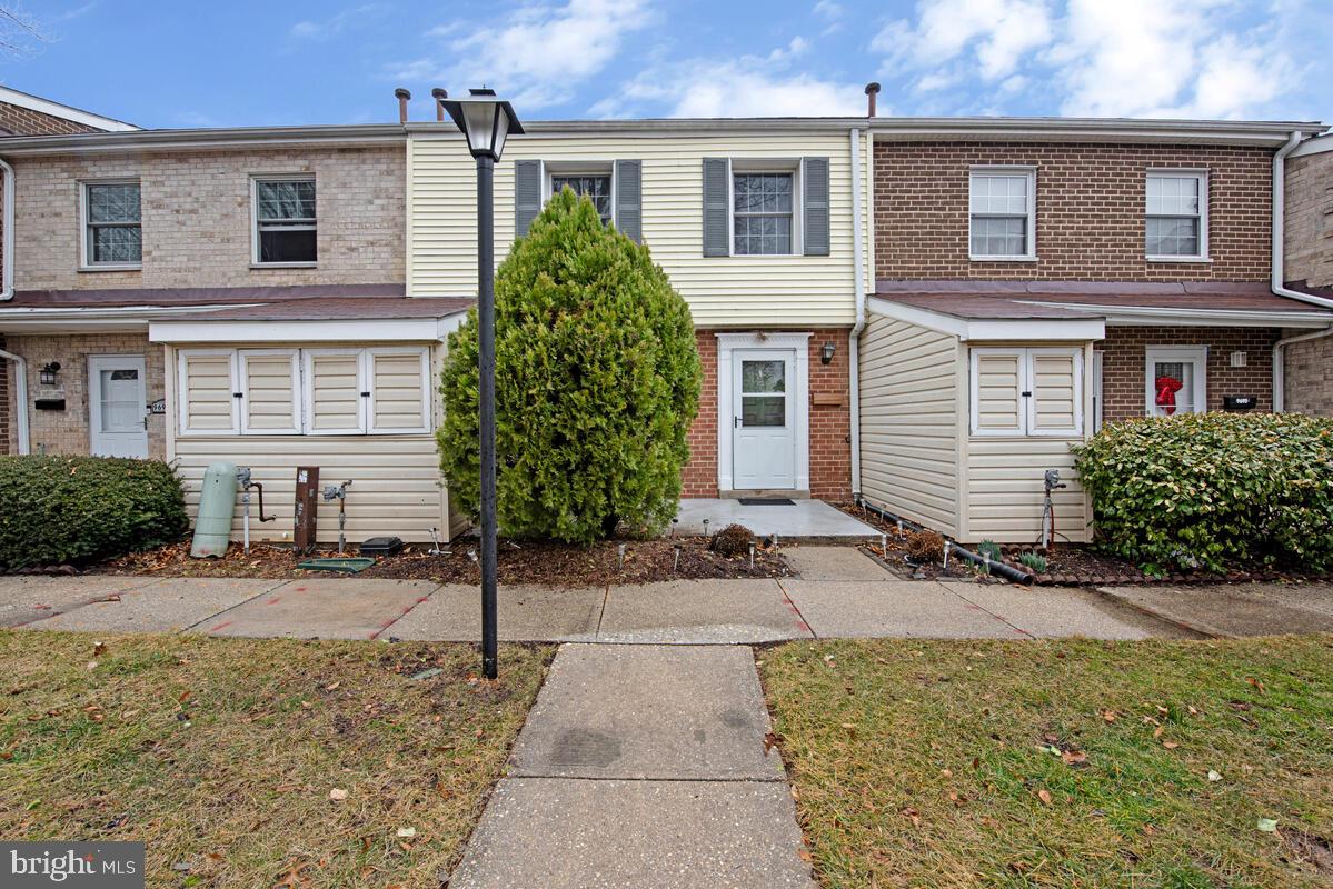 9695 Hitching Post Lane, Unit H Laurel, MD 20723 - Photo 1 of 19 a front view of a house with garden
