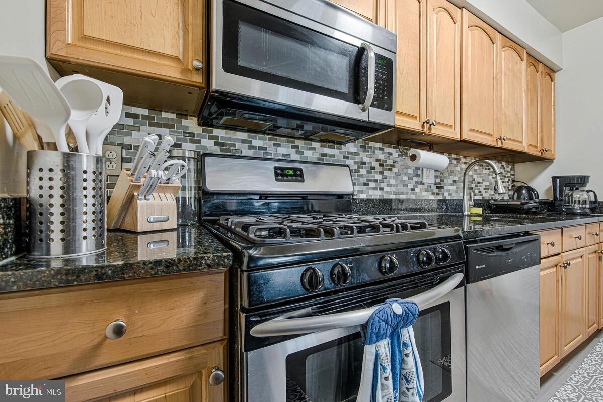 9695 Hitching Post Lane, Unit H Laurel, MD 20723 - Photo 12 of 19 a kitchen with a stove and a microwave