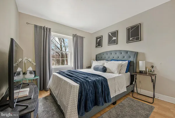 a bedroom with a bed and wooden floor