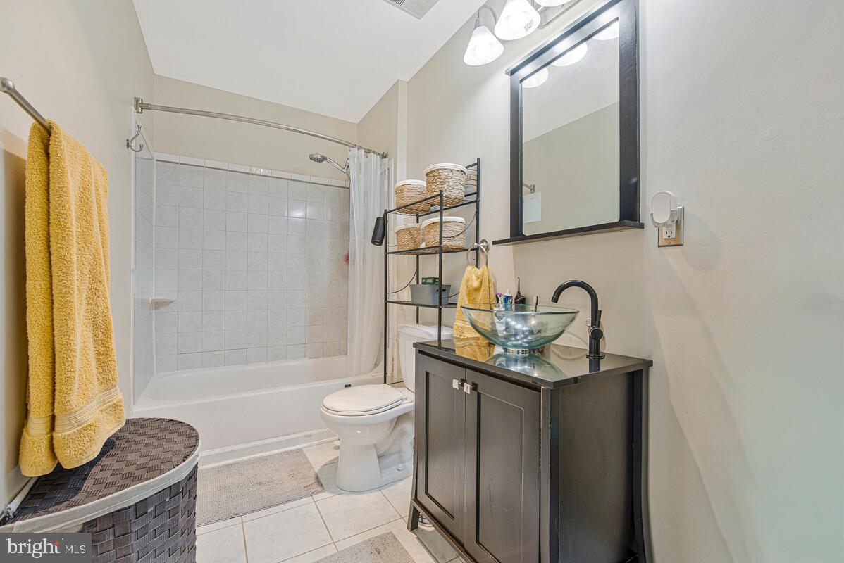 9695 Hitching Post Lane, Unit H Laurel, MD 20723 - Photo 14 of 19 a bathroom with a granite countertop sink toilet and shower