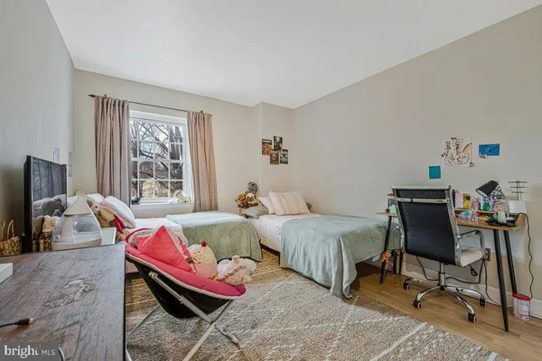 a bedroom with two beds and a window