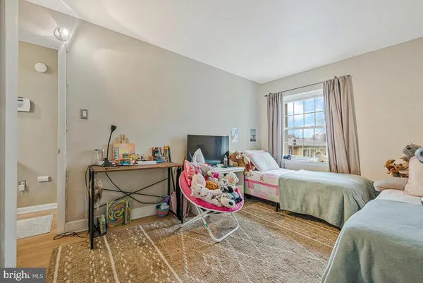 a living room with two beds and a window