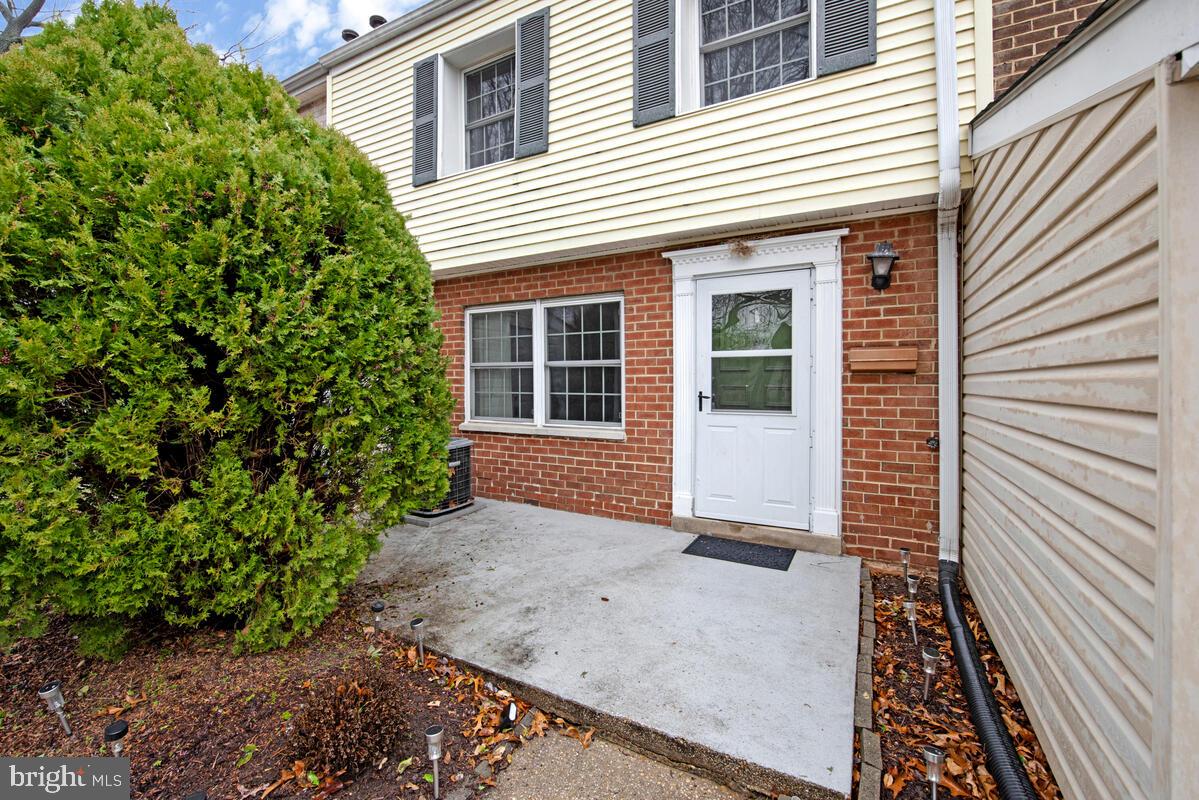 9695 Hitching Post Lane, Unit H Laurel, MD 20723 - Photo 18 of 19 a view of a house with a yard