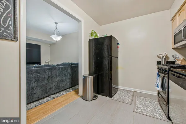 a kitchen with stainless steel appliances granite countertop a refrigerator and a stove