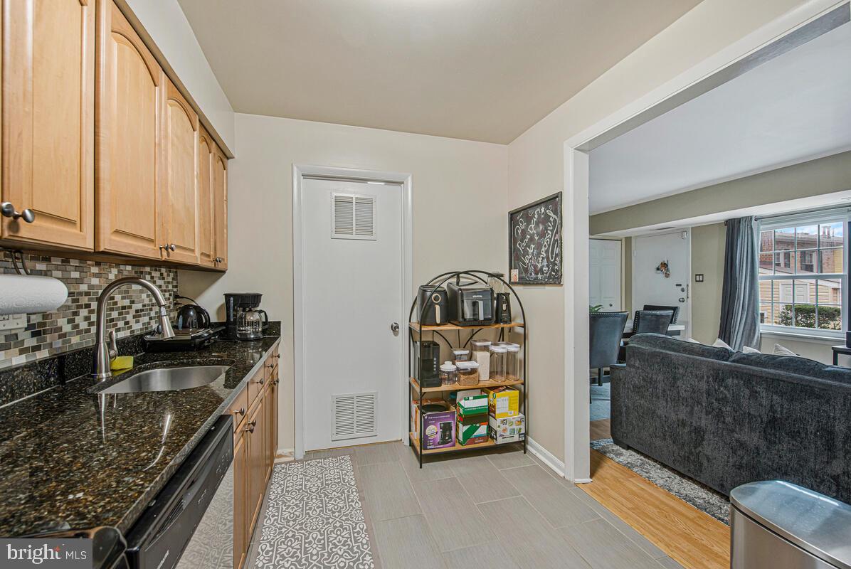 9695 Hitching Post Lane, Unit H Laurel, MD 20723 - Photo 10 of 19 a kitchen with stainless steel appliances granite countertop a stove and a refrigerator