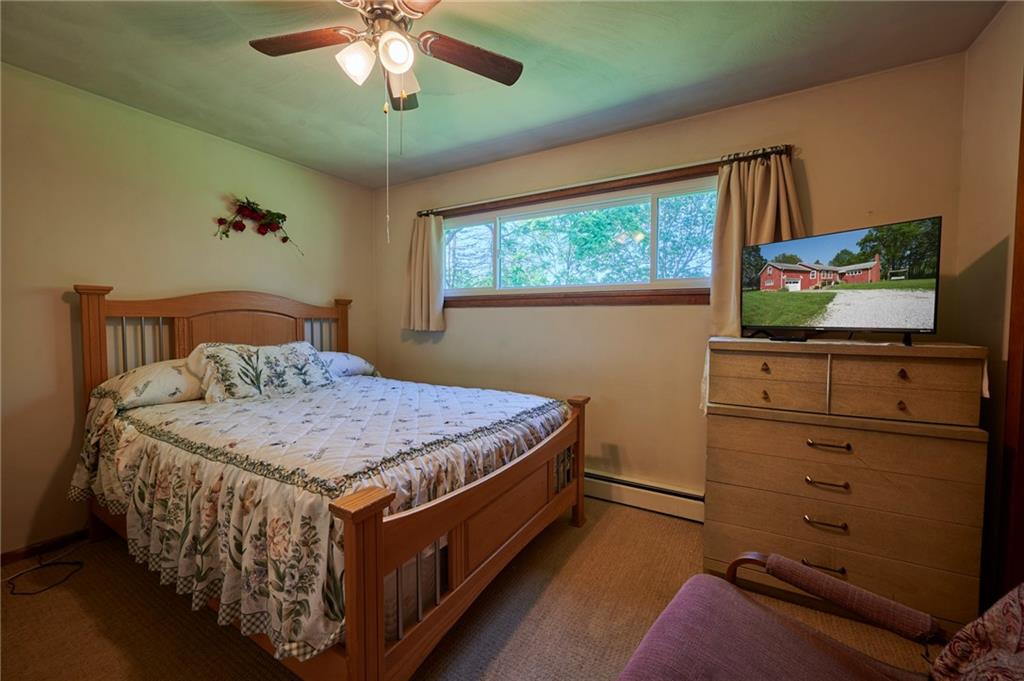 2583 Highway 210 Rural Valley, PA 16249 - Photo 13 of 41 a bedroom with a bed and a flat screen tv