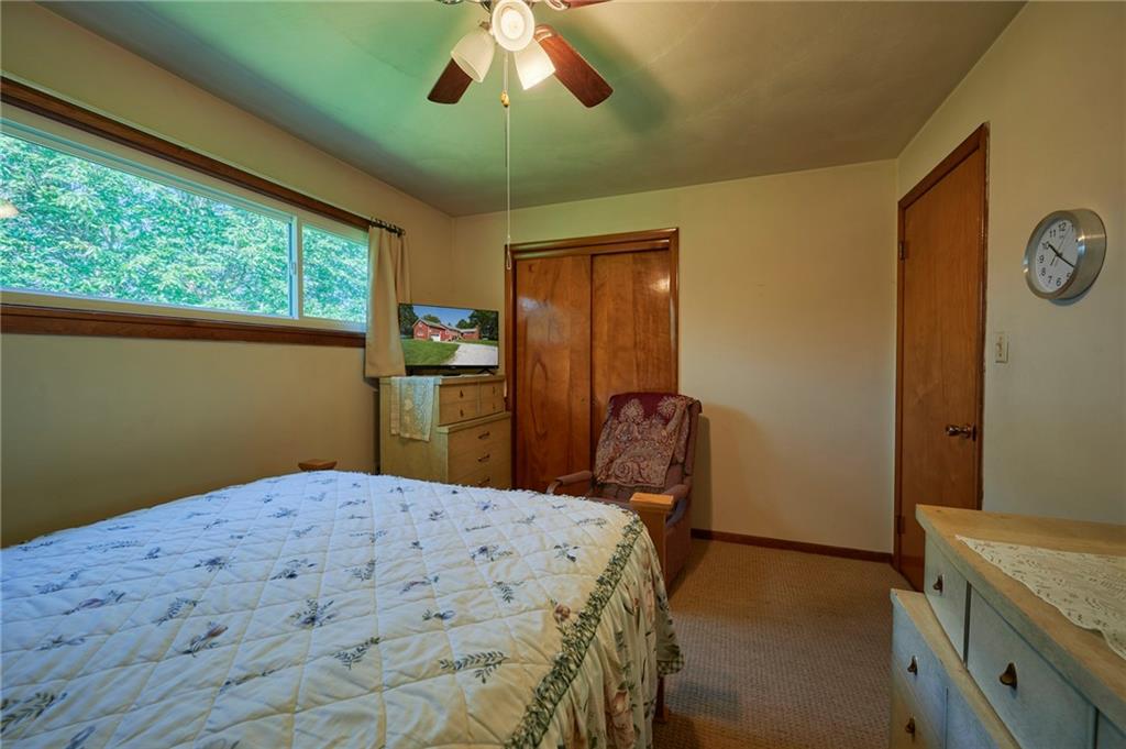 2583 Highway 210 Rural Valley, PA 16249 - Photo 14 of 41 a bedroom with a bed and a chandelier